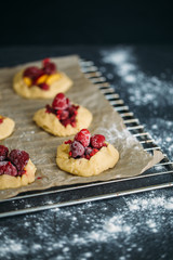 Delicious ready for baking mini tarts with fresh berries and fruits on food lattice