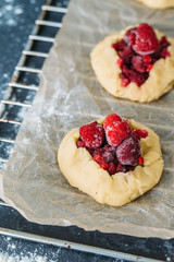 Delicious ready for baking mini tarts with fresh berries and fruits on food lattice