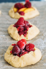 Delicious ready for baking mini tarts with fresh berries and fruits on food lattice
