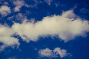 cumulus clouds float across the blue sky