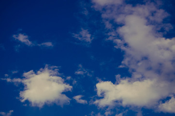 cumulus clouds float across the blue sky