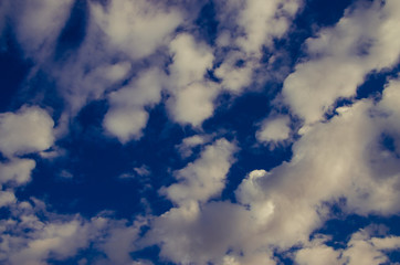 cumulus clouds float across the blue sky