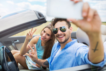 Couple taking a selfie while out on a road trip
