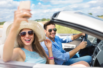 Couple taking a selfie while out on a road trip
