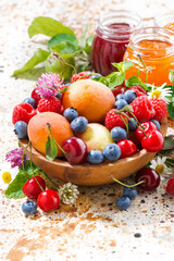 assortment of seasonal fruits and berries, jams, vertical 