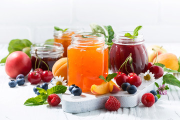 assortment of sweet jams and seasonal fruits