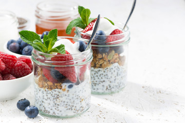Breakfast in a jar with chia, berries and oat flakes 