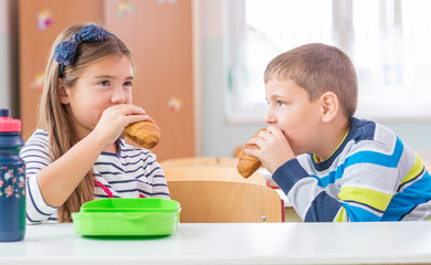 Obraz na płótnie Canvas .Children at school - they snack