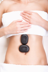 Hot stones on a woman's tummy
