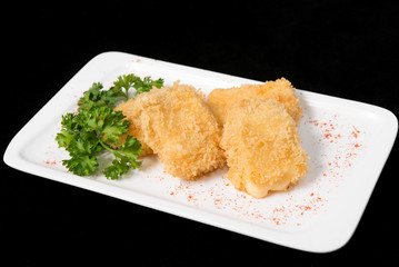 Fried cheese suluguni on white plate on black background