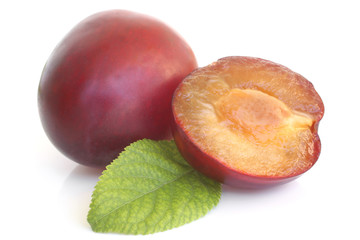 Plums with green leaf