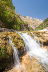 Fototapeta na wymiar The natural reserve Cavagrande, Sicily, with a view of a smal fall and of the canyon