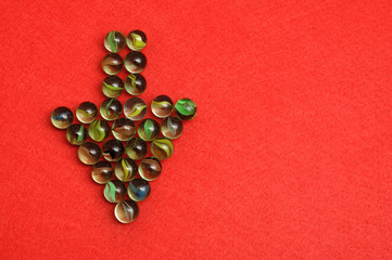 Marbles displayed in a arrow shape on red background