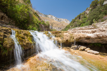 Fototapeta na wymiar The natural reserve Cavagrande, Sicily, with a view of a smal fall and of the canyon