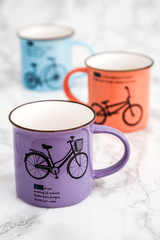 Colorful Modern Ceramic Mugs on White Marble Background	