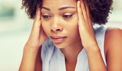close up of african young woman touching her head