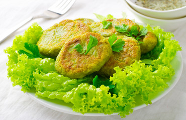 Vegetarian patties of broccoli with pepper, greens and herbs, on white background