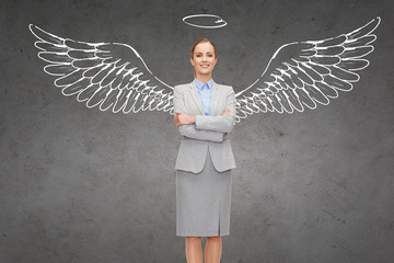 happy businesswoman with angel wings and nimbus
