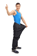 Man in oversized jeans giving thumb up