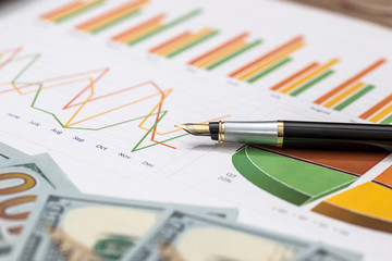 business graph with money and pen