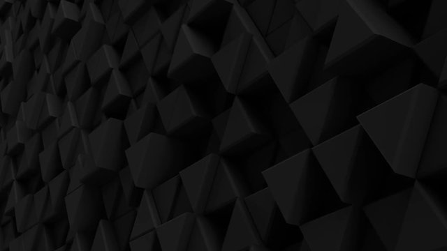 Black wall of extruded triangles. Seamless loop smooth animation with motion blur. Abstract 3D render 4k UHD (3840x2160)
