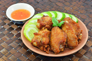 Fried chicken wings in batter with sauce