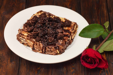 Cream cake with chocolate on wooden background