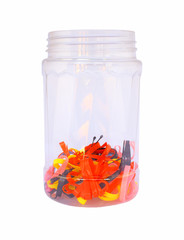 Colorful rubber bands in a bottle on white background