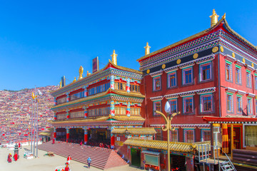 Red monastery at Larung gar (Buddhist Academy) in sunshine day and background is blue sky, Sichuan, China