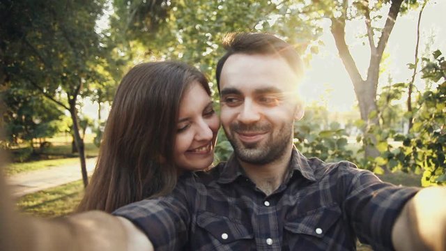young couple is take selfie in park