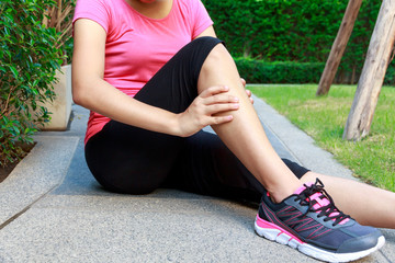 Asian sporty woman leg pain or calf muscle while jogging or running