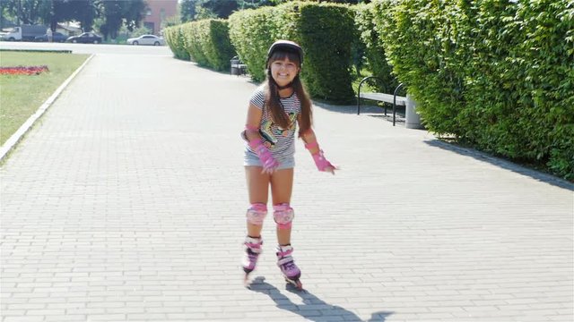 Funny girl riding on roller skates / Funny girl riding on roller skates. Outdoors.