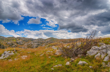 Montenegro, national park Durmitor, mountains and clouds panorama. Sunlight lanscape. Nature travel background