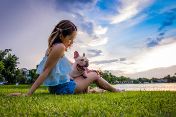French Bulldog and owner in the Morning sunshine ,lake view Green park