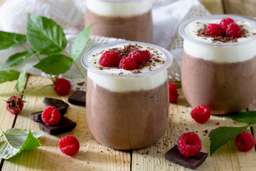 Homemade chocolate mousse with raspberries on a table in a rusti