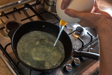 Cooking process of frying huge ostrich egg on frying pan