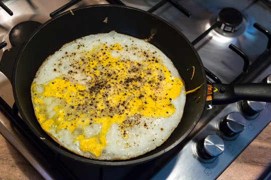 Cooking process of frying huge ostrich egg on frying pan