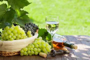 White wine bottle and glass, red and white grape