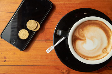 cup of coffee on the table and the phone