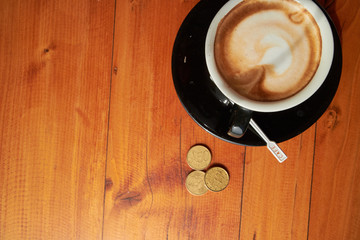 cup of coffee on the table and coins