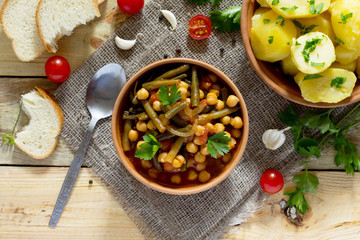 Vegetarian vegetable stew with chickpeas and green beans on a ru