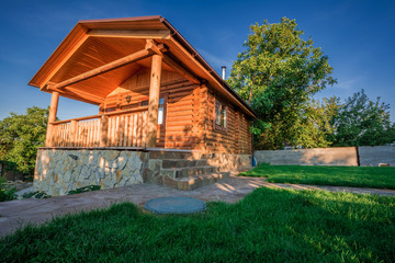 Wooden house with meadow in front of it