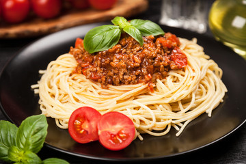Spaghetti bolognese on dark background