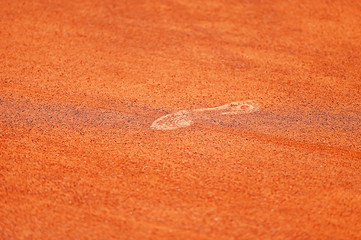 Footprint on tennis clay court
