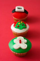 Christmas cupcakes on red background

