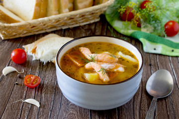 Tomato soup with red fish in a ceramic bowl on a napkin, tomatoe