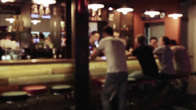 Group of people is sitting in a bar, Defocused background