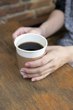 Hand holding cup of coffee