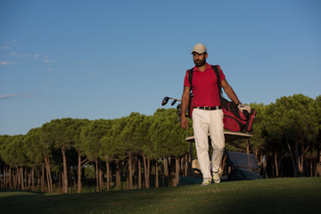 golfer  walking and carrying golf  bag