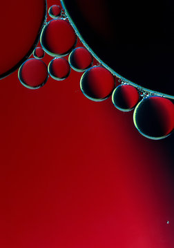 Abstract macro background of red and black bubbles in water.